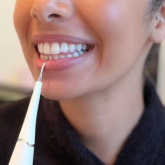 lady uses Clearpik in bottom teeth